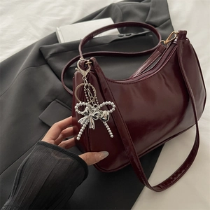Classic wine red glossy hobo shoulder bag with a silver beaded bow charm accessory