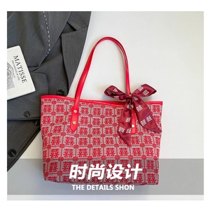 Detail of red woven jacquard tote bag with traditional Double Happiness pattern and silk scarf