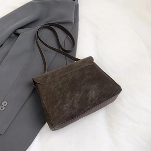 Retro dark brown large capacity crossbody bag for women on grey suit jacket