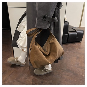 Brown large capacity tote bag with adjustable wide shoulder strap and soft draped texture