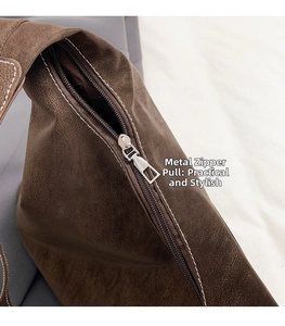 Macro shot of brown retro faux leather tote bag with white stitching and silver zipper