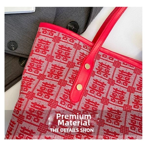 Detail of red bridal tote bag with woven Double Happiness pattern and gold metal hardware
