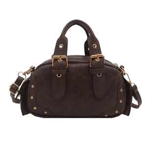 Retro dark brown bowling handbag with adjustable strap and vintage brass rivets on white background