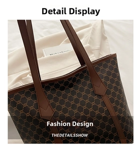 Close-up of vintage printed tote bag with brown leather handles and reinforced stitching