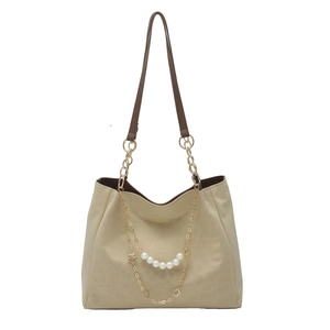 Large beige tote bag with brown leather straps and gold clover pearl chain detail