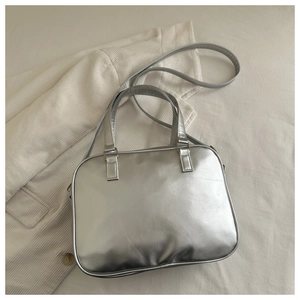 Close-up of a silver Boston pillow bag with leather texture and detachable shoulder strap