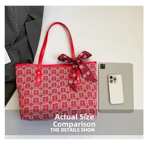 Close-up of red woven tote bag featuring festive double happiness pattern and matching silk scarf