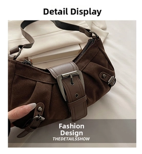 Detailed macro of the vintage brown suede texture and metal buckle on the biker bag