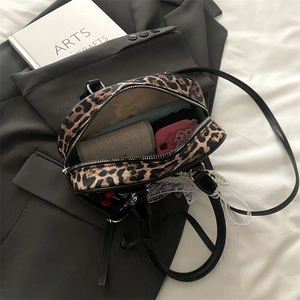 Retro leopard print crossbody bag showing spacious interior with everyday essentials
