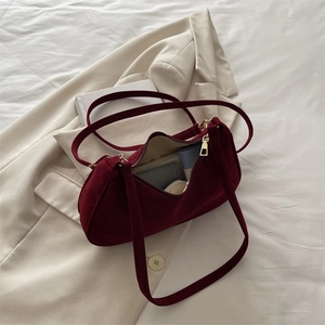 Deep red suede shoulder bag with gold zipper showing daily storage capacity for women
