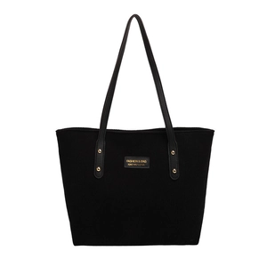 Classic black striped tote bag with leather straps and gold rivets on white background