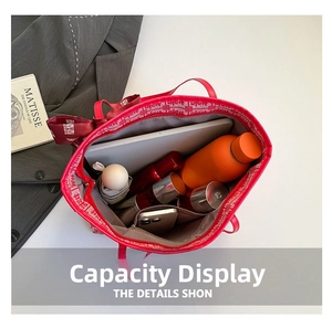Spacious red tote bag interior showing capacity for laptop, water bottle and essentials