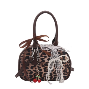 Leopard print Boston bag with bow and cherry charms for women, 45-degree angle view