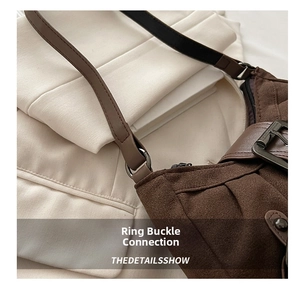 Detailed close-up of dark brown suede bucket bag with metal buckle and pleated design