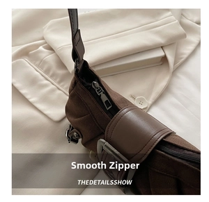 Detail of vintage brown shoulder bag showing suede texture and retro buckle ornament