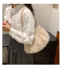 Close-up of soft beige plush tote bag featuring elegant light brown leather shoulder strap