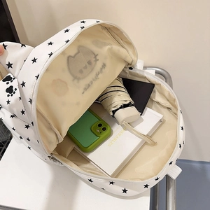 Cute white cat-ear backpack with star prints showing spacious internal storage for books