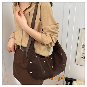 Detail of dark brown suede hobo bag featuring polished gold studs and a side view