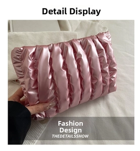 Macro detail of pink metallic quilted makeup bag with soft padded cloud texture