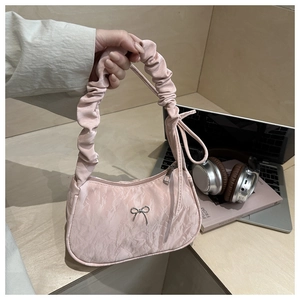 Pink pleated satin handbag featuring silver bow detail and metallic zipper closure