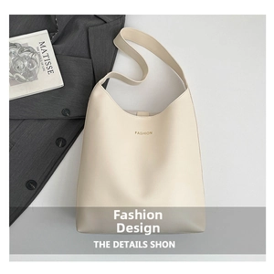 Détail du sac cabas en cuir crème avec logo FASHION doré et bandoulière intégrée