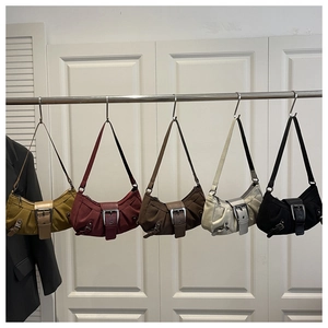 Five vintage Y2K hobo bags in various colors with large metal buckles and pleat details