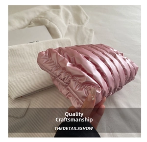Macro detail of pink quilted cloud pouch with metallic finish and puffy texture
