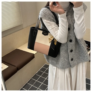 Fashion tote bag with three-color stitching and silk scarf accessory shown on model