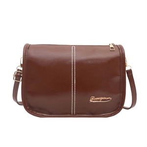 Brown leather crossbody bag with white stitching and gold hardware on white background