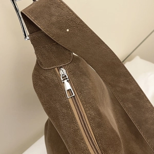 Brown faux suede shoulder bag with wide strap and silver zipper detail for women