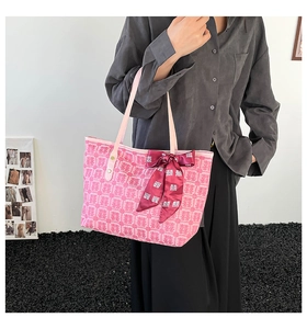 Detail of pink wedding tote bag with traditional red pattern and red silk scarf bow