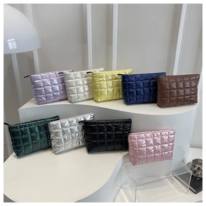 Close-up of quilted padded cosmetic bags in multiple colors displayed on steps