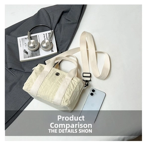 Close-up of beige nylon tote bag with wide strap and urban commute accessories