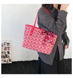 Macro detail of red wedding tote bag with double happiness jacquard and ribbon decor