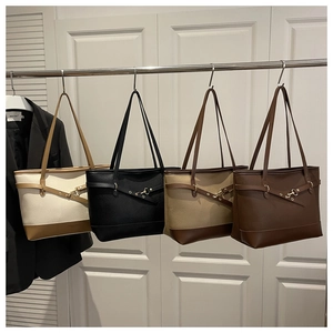 Close-up of four minimalist faux leather tote bags in beige, black, khaki and brown