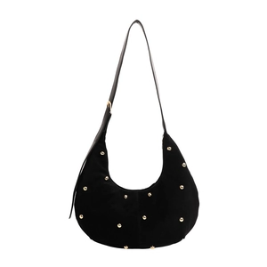 Black suede hobo shoulder bag with gold studs and adjustable strap on white background