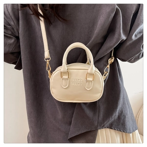Chic cream leather handbag featuring embossed lettering and detachable shoulder strap