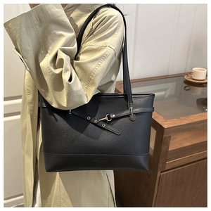 Detail of black pebbled leather tote bag with gold buckle and Fashion & Bags text logo