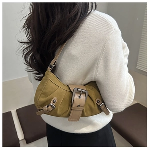 Detail view of olive green retro shoulder bag with vintage buckles and leather strap