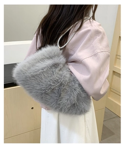 Detail showing the fluffy texture and heart-shaped design of the grey plush tote bag
