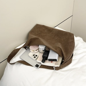 Retro brown faux suede tote bag with wide shoulder strap showing large interior capacity