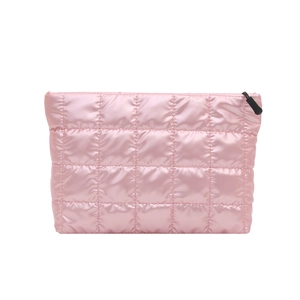 Pink quilted travel makeup bag with satin finish and black zipper on white background