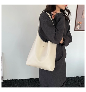Vue détaillée d'un grand sac cabas en cuir blanc minimaliste avec lettrage doré