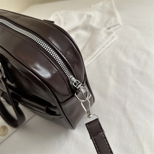 Dark brown leather Boston shoulder bag with silver zipper and detachable strap detailing