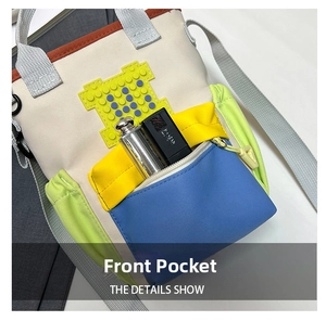 Close-up of front zipper pocket on canvas crossbody bag with colorful pixel silicone patches