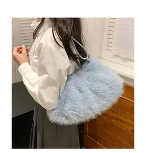 Detailed texture of light blue plush tote bag on model showing soft faux fur material