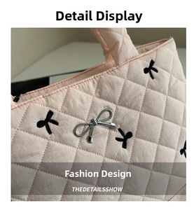 Close-up of pink quilted tote bag showing rhombus texture and silver bow detail