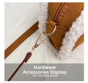 Close-up of golden metal hooks and soft faux shearling trim on a brown suede pillow bag