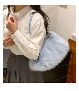 Close-up of soft light blue plush tote bag worn by model with minimalist school outfit
