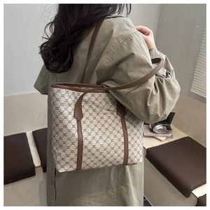 Detailed view of the vintage monogram tote bag shown from a stylish side-back angle